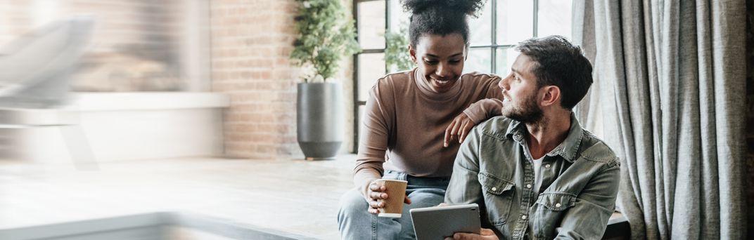 A man a woman review their savings account over coffee.